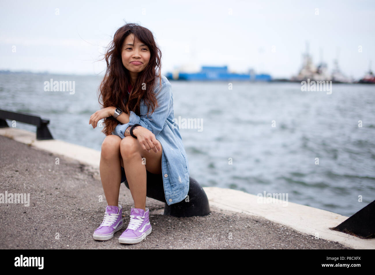 A young Asian (Filipino) woman wears casual clothes in various spots around Ontario. Stock Photo