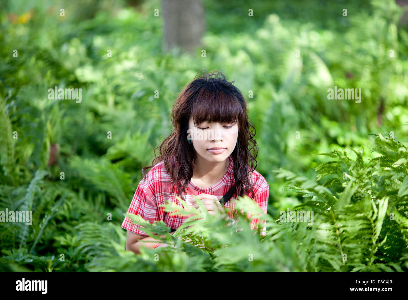 A young Asian (Filipino) woman wears casual clothes in various spots around Ontario. Stock Photo