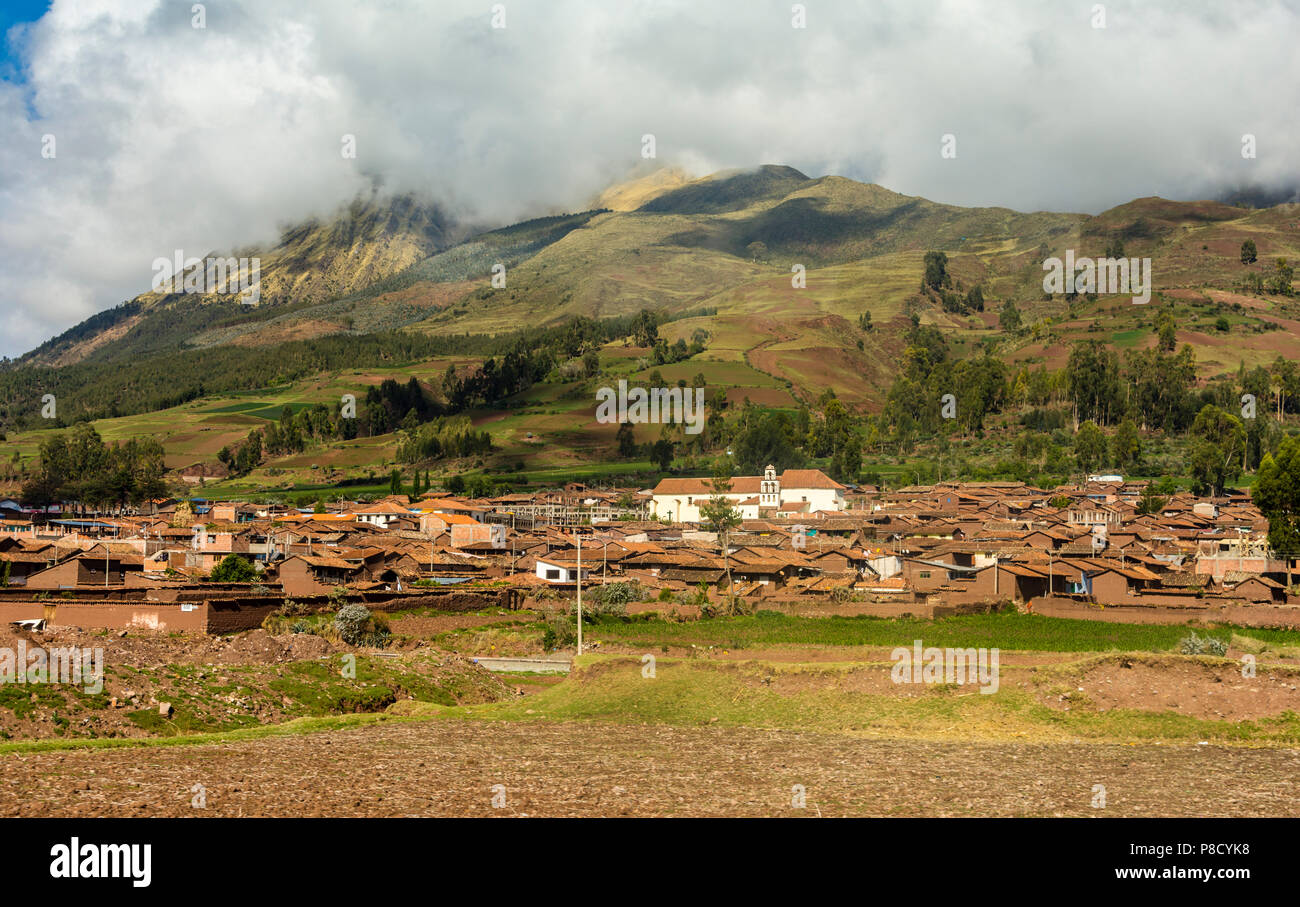 Rural residential community surrounded by green farmland near Cusco, Cuzco, Peru, South America. Stock Photo