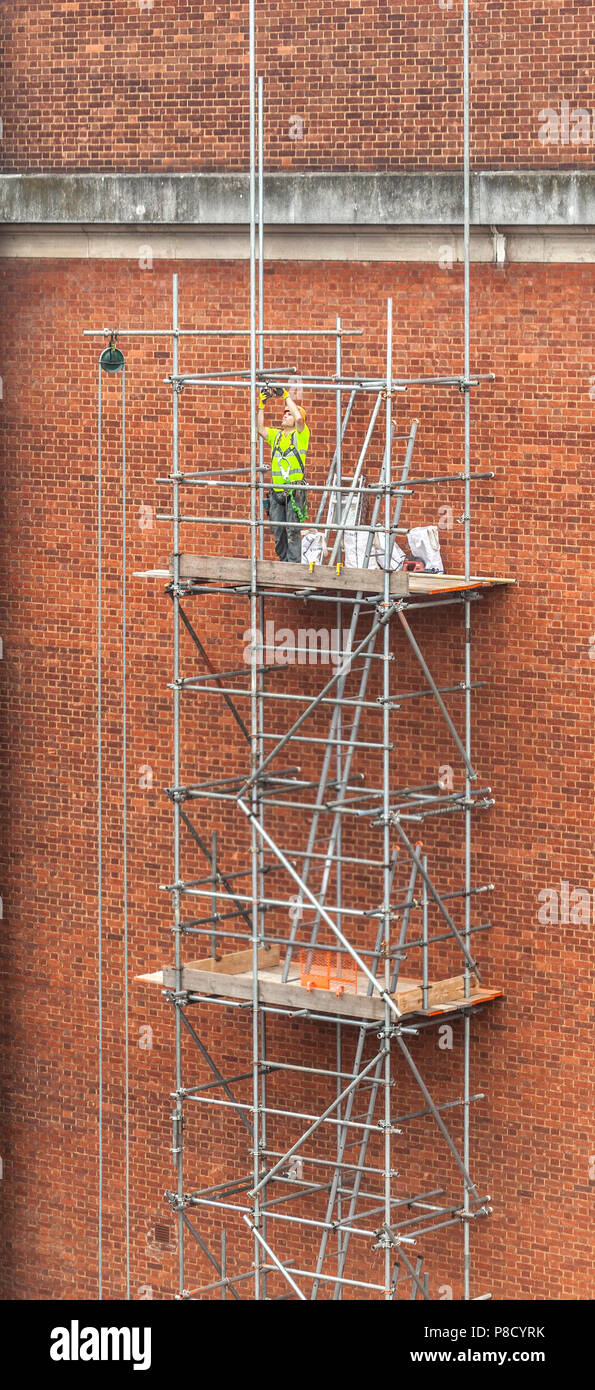 Scaffolding contractor at work on high platform Stock Photo Alamy
