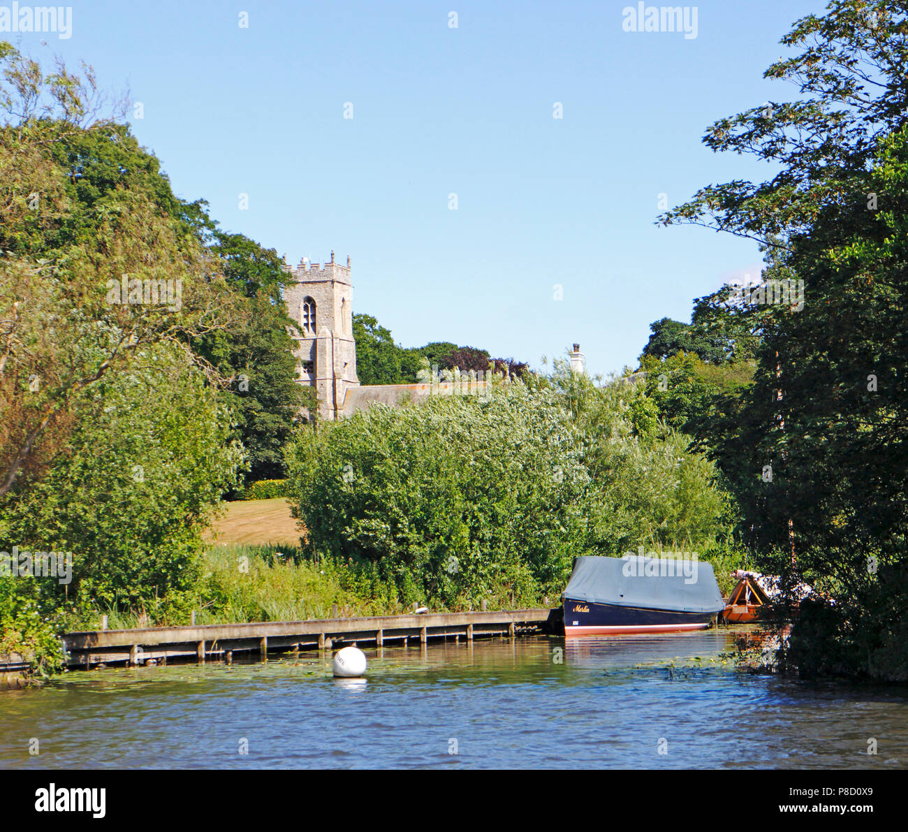 A view of the parish church of St Benedict from the River Bure on the