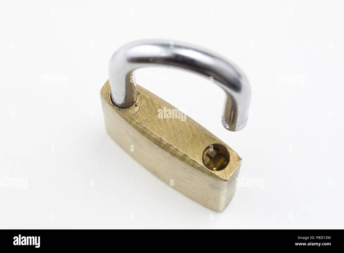 Brass padlock on a white table. Accessories for locking and securing ...