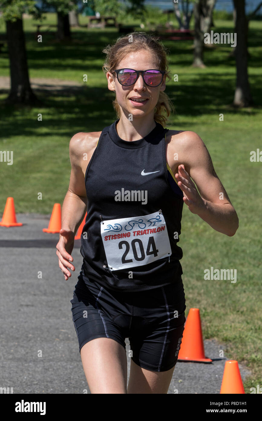 Mariola Moeyaert competiting in the run segment in the 2018 Stissing Triathlon Stock Photo