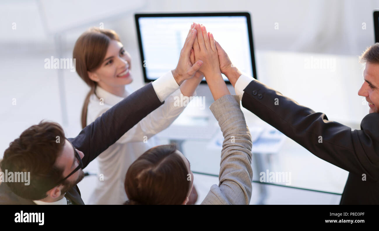 successful business team giving each other a high five Stock Photo - Alamy