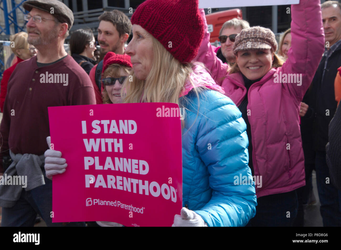 Asheville, North Carolina, USA – January 20, 2018: A female demonstrator in the American 2018 Women's March holds a sign that says 'I STAND WITH PLANN Stock Photo