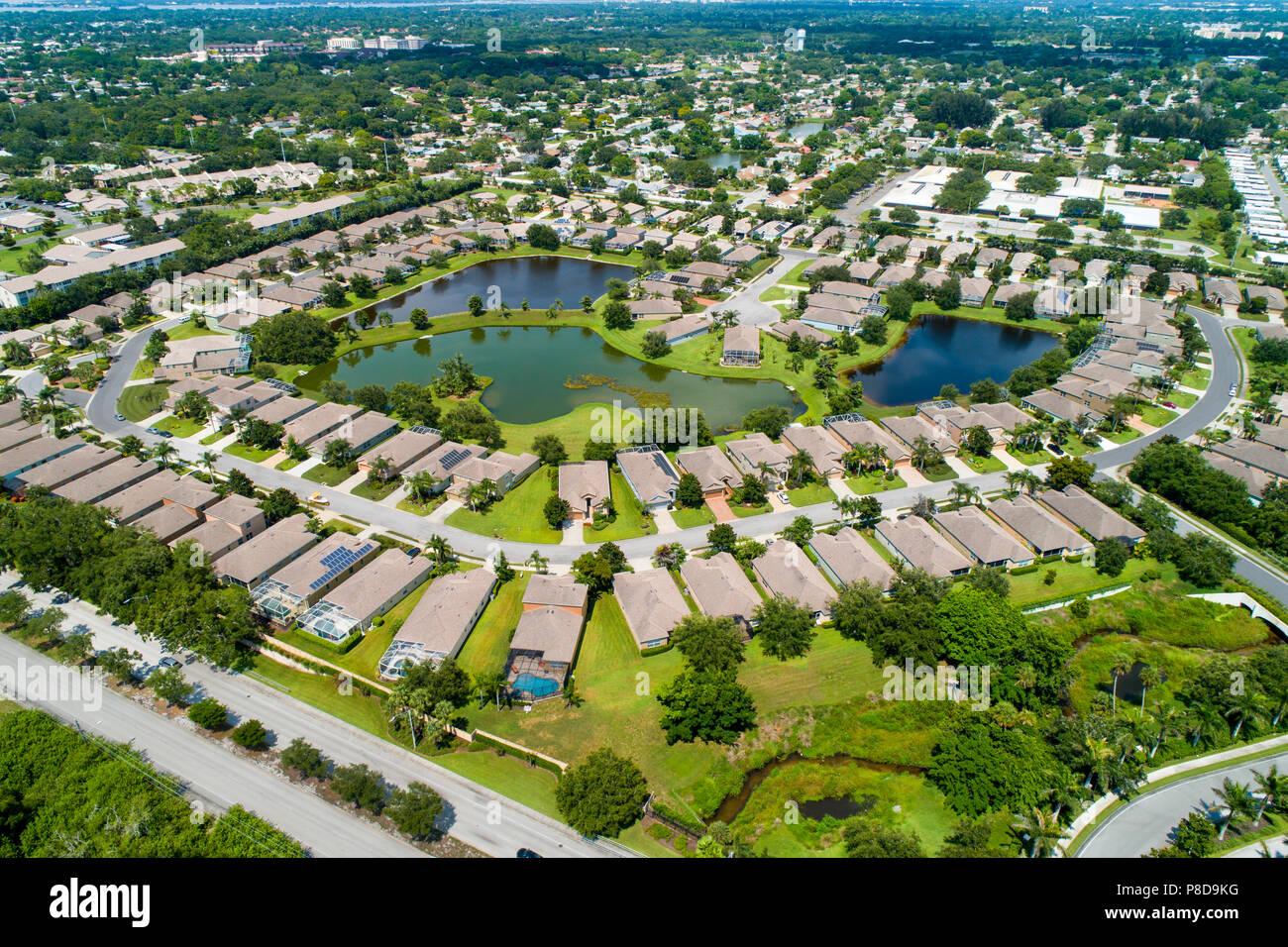 Aerial view of a Planned Bradenton Florida residential 55+ retirement community of single family condominium homes surrounding a small lakes with a ga Stock Photo