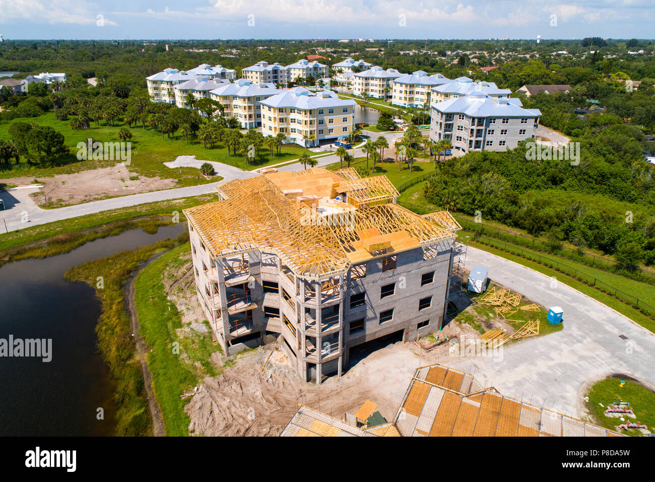 Aerial view of Condominium new home construction showing wood trusses atop on a cement block of 9 individual home units Stock Photo
