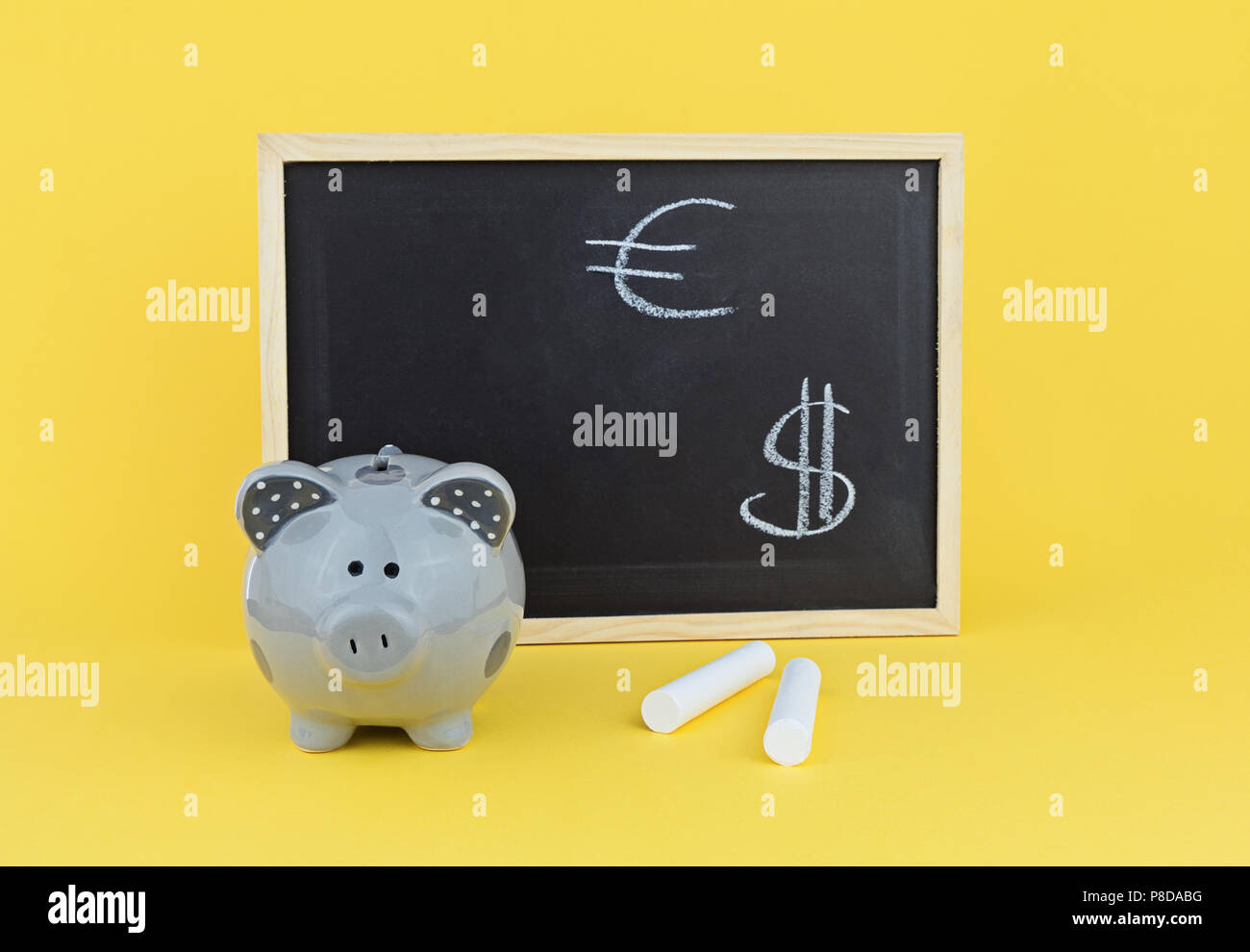 Funny pig piggy bank on background of chalk board with signs of the ...