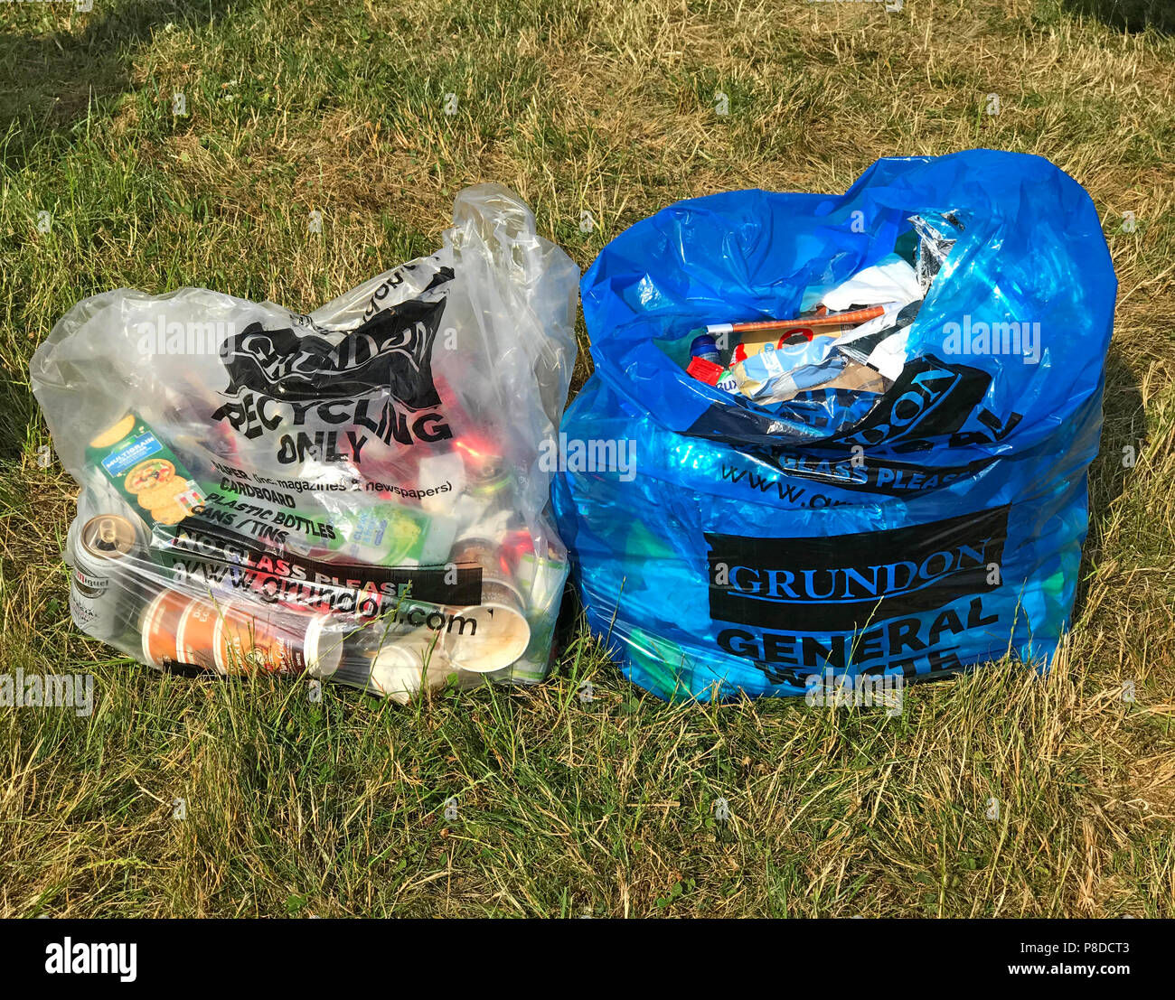 Two campsite bags, general waste and recycling camping field, clear bag, blue bag, Grundon , Recycling Only Stock Photo