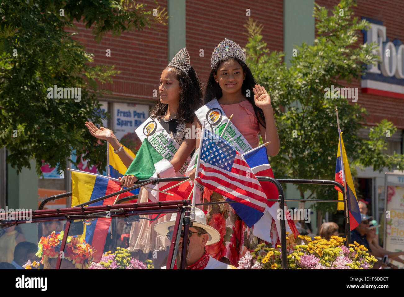 Hispanic beauty queens in the 9th Annual Flower Parade (Desfile de las Flores) in the Jackson Heights neighborhood of Queens in New York on Sunday, July 8, 2018. The parade, complete with silleteros, flower sellers, carrying medallions of flowers on their backs like the silleteros who carry them on their backs down the mountains in Colombia around the city of Medellin to sell at market. Stock Photo