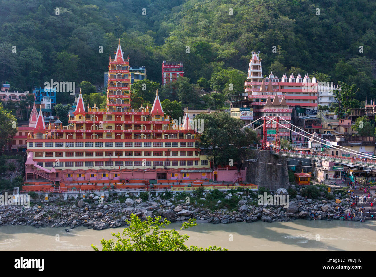 View of Ganga river embankment, Lakshman Jhula bridge and Tera Manzil Temple, Trimbakeshwar in Rishikesh Stock Photo