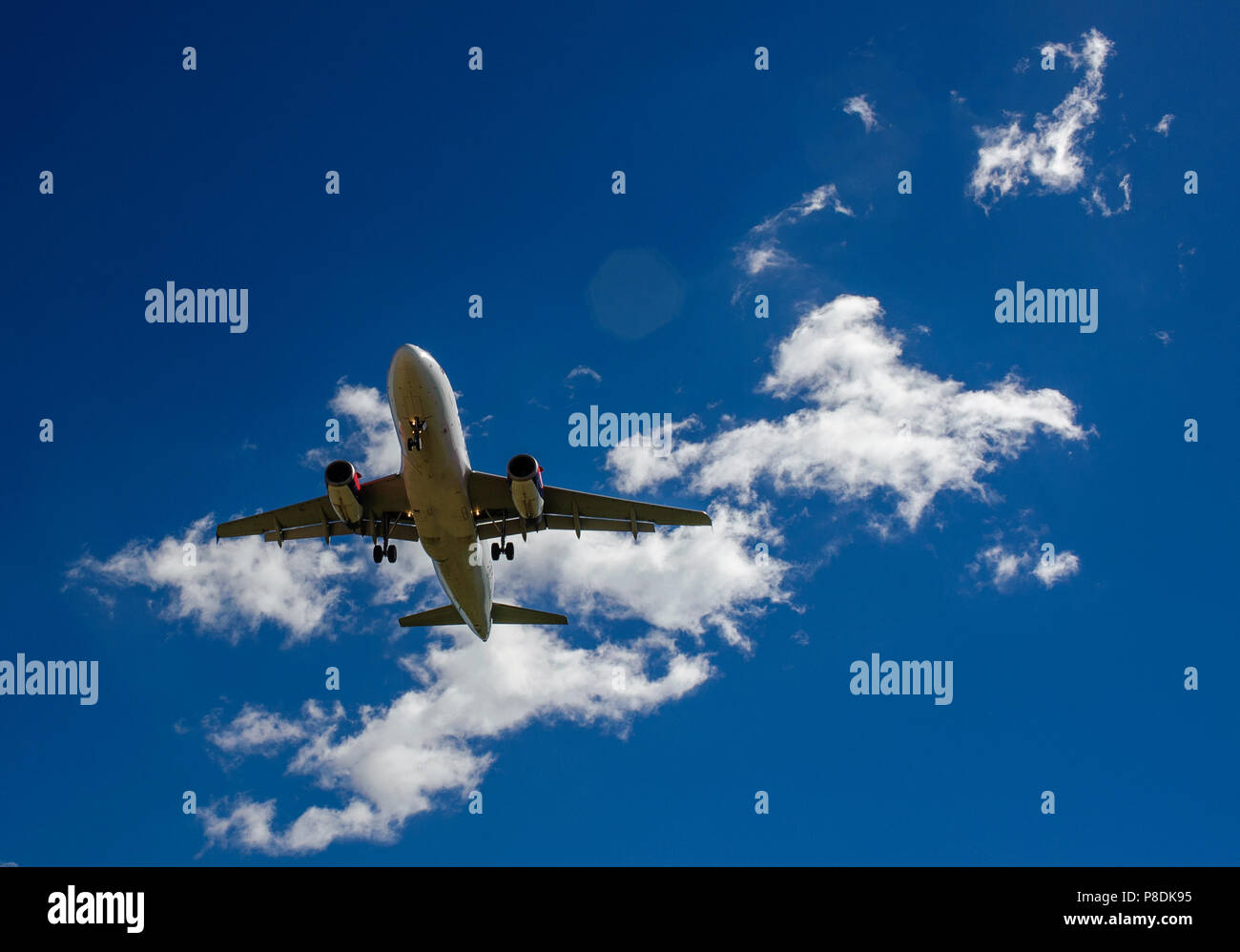 The plane on a background of blue sky and white clouds Stock Photo - Alamy