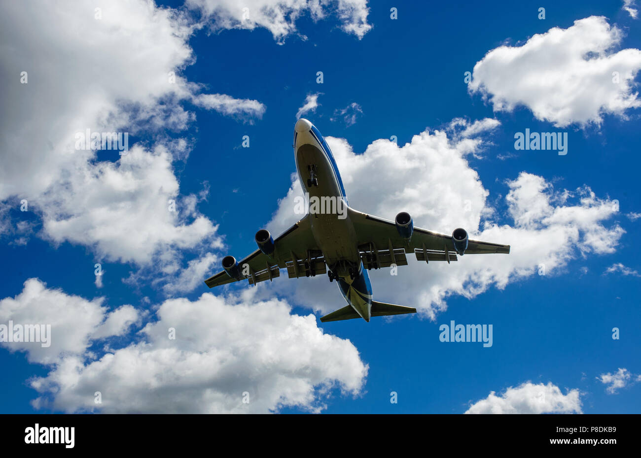 The plane on a background of blue sky and white clouds Stock Photo - Alamy