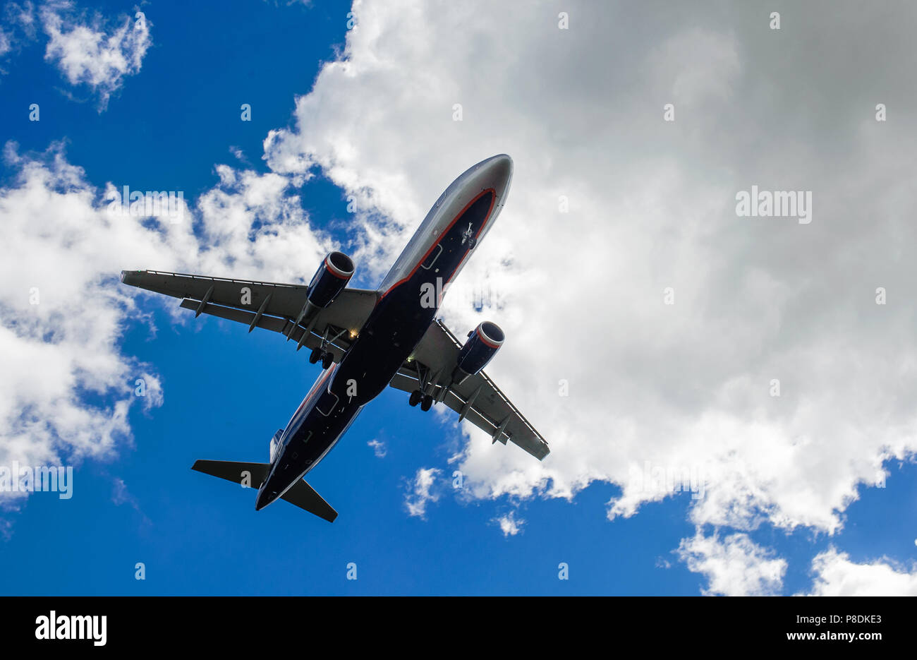 The plane on a background of blue sky and white clouds Stock Photo - Alamy