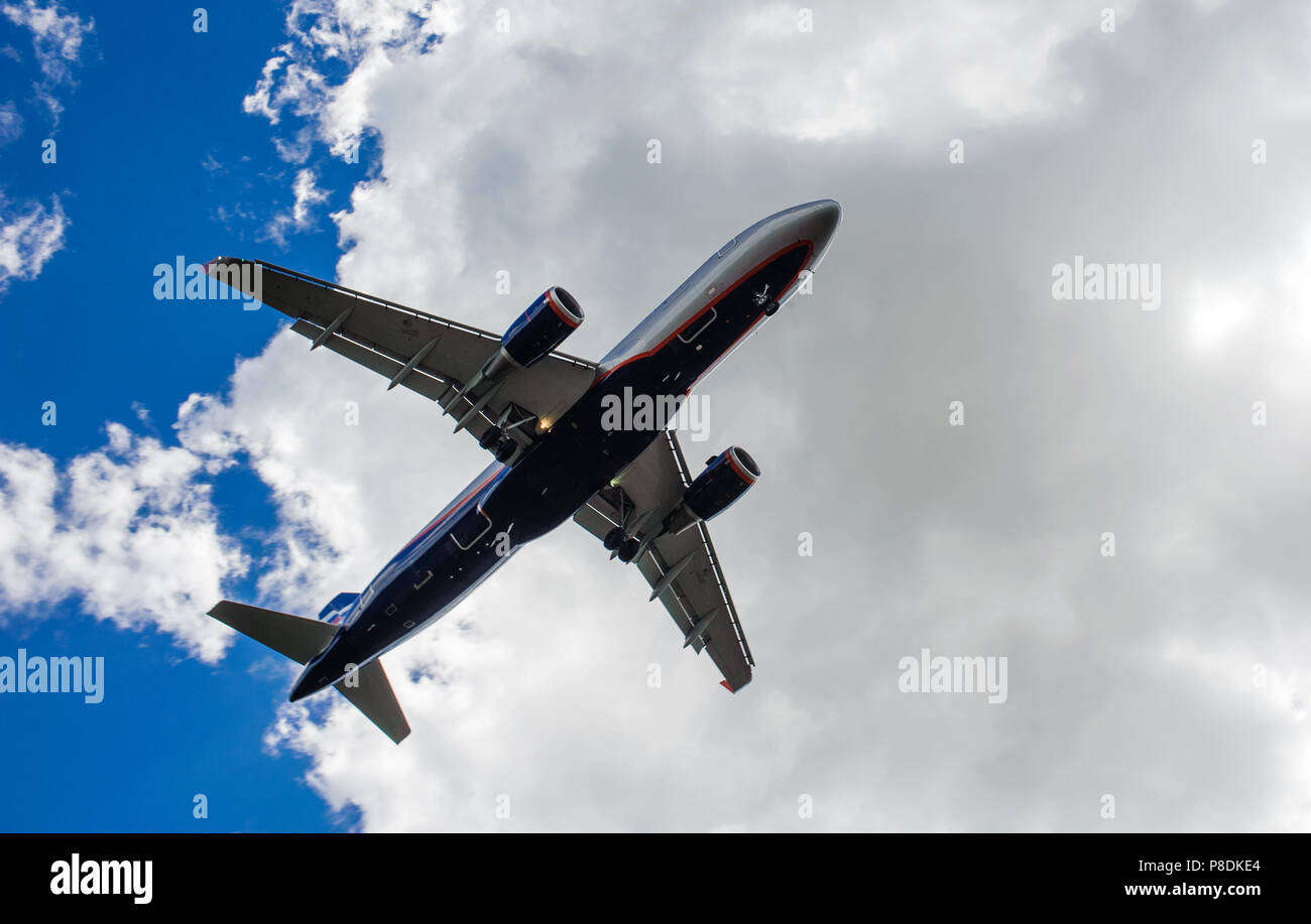 The plane on a background of blue sky and white clouds Stock Photo - Alamy
