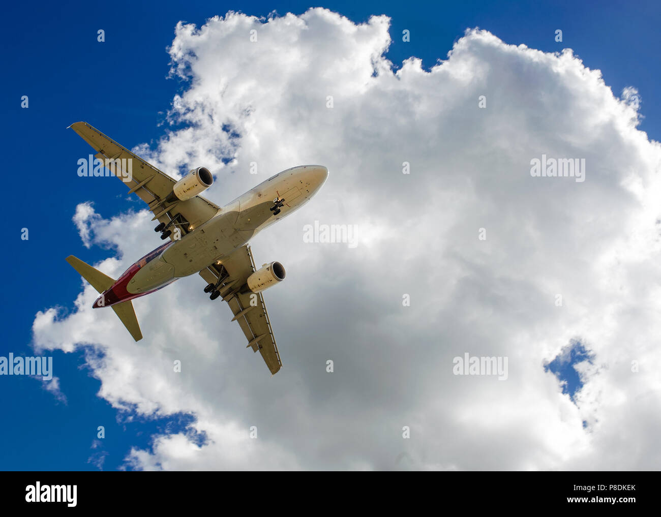 The plane on a background of blue sky and white clouds Stock Photo - Alamy