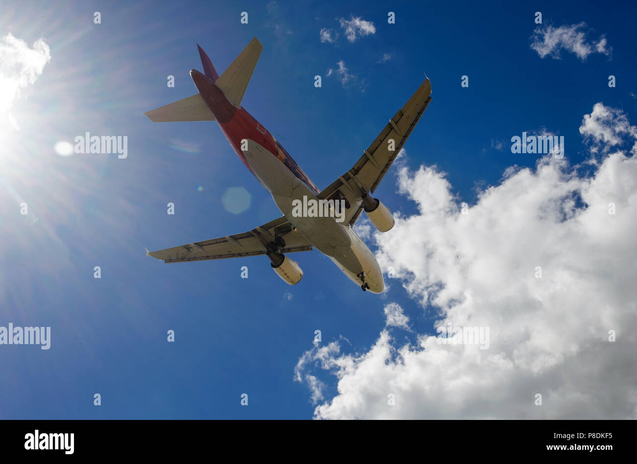 The plane on a background of blue sky and white clouds Stock Photo - Alamy