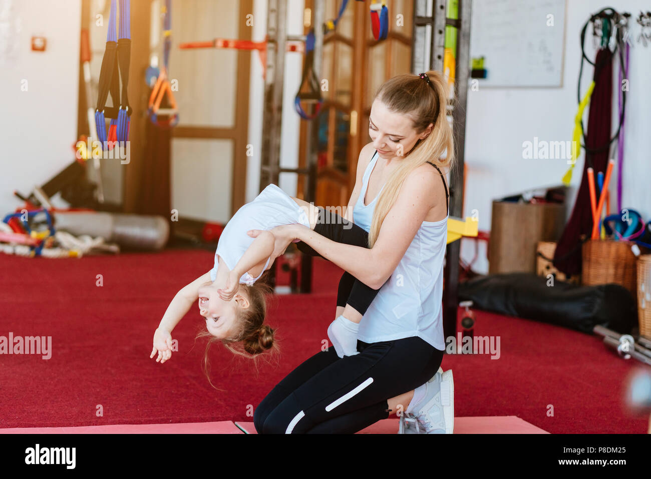Mom and daughter together perform different exercises Stock Photo Alamy