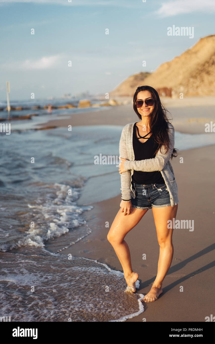 Young beautiful girl posing by the sea Stock Photo - Alamy