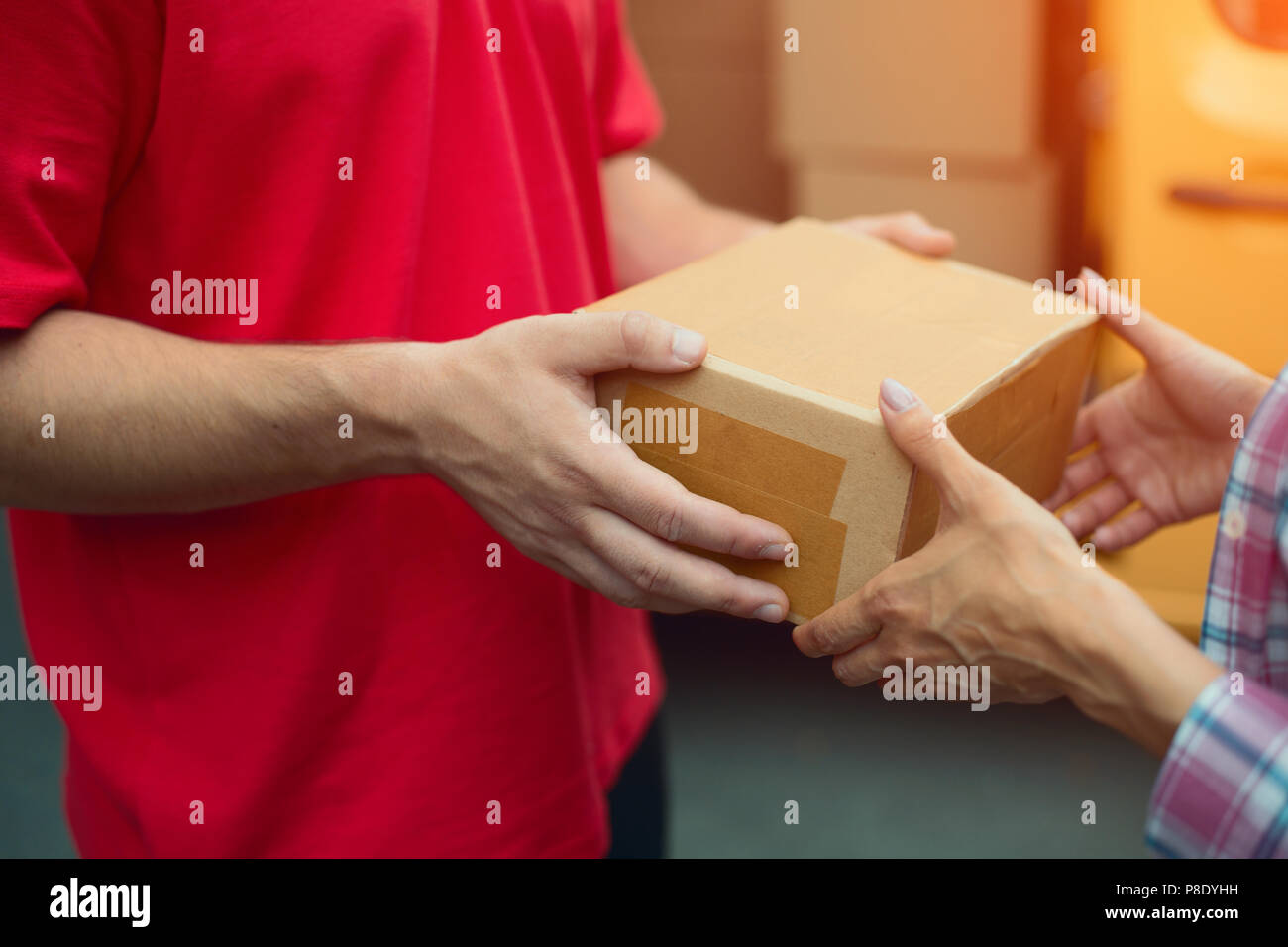 Delivery man handing package box Stock Photo Alamy