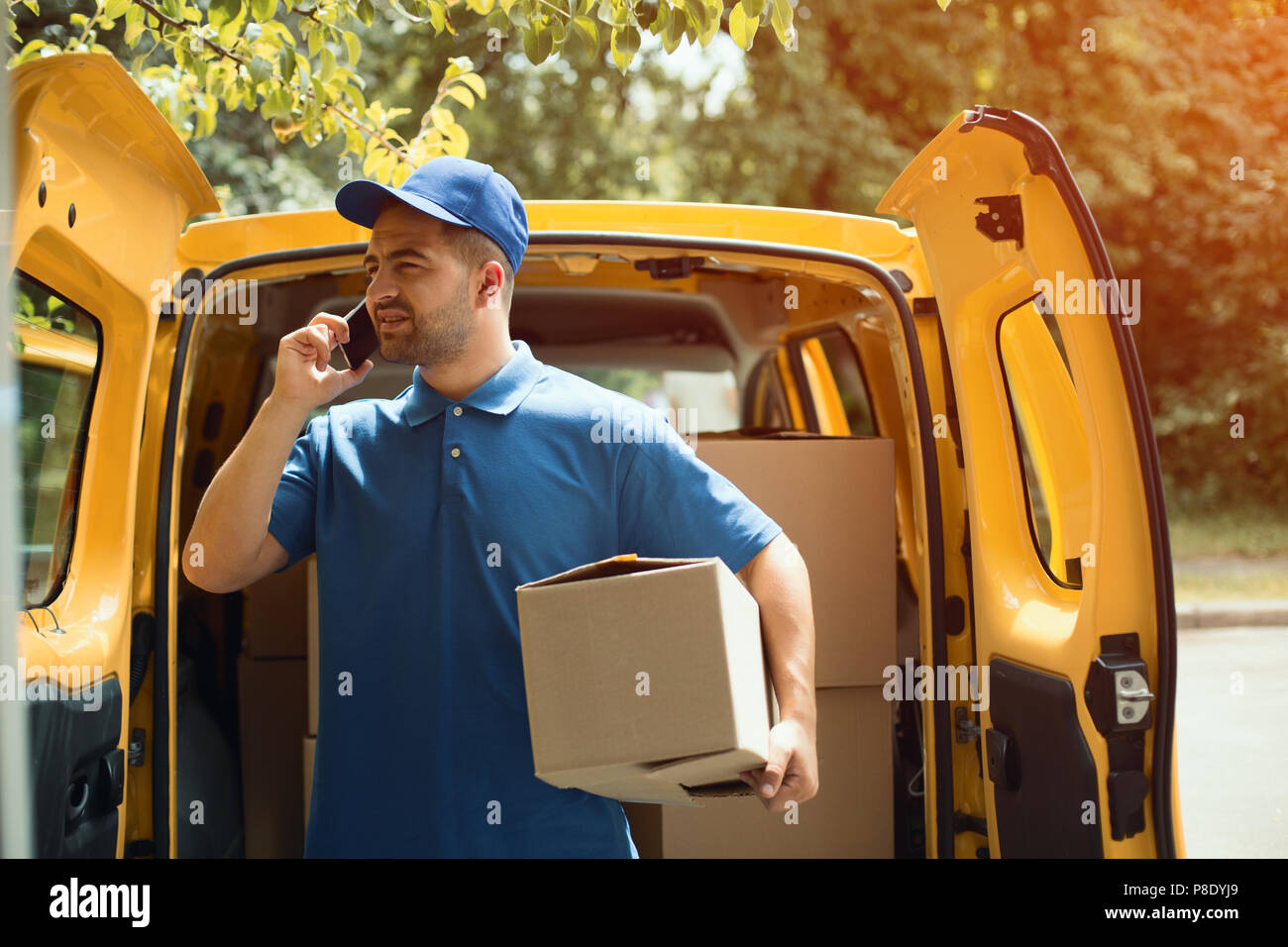 Delivery guy holding package Stock Photo Alamy