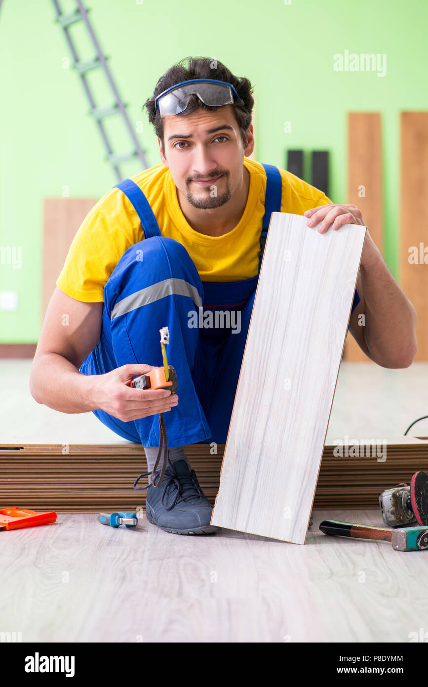 Professional contractor laying flooring at home Stock Photo Alamy