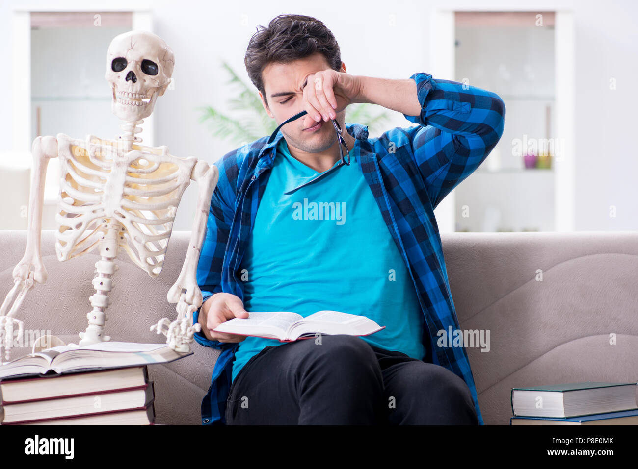 Student studying with skeleton preparing for exams Stock Photo