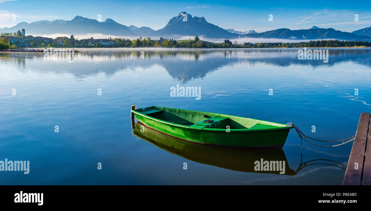 Green rowboat, lake Hopfensee, Hopfen am See, near Füssen, Ostallgäu, Allgäu, Bavaria, Germany Stock Photo