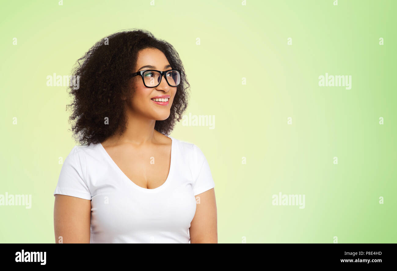 Positive african woman in green hi-res stock photography and images - Alamy