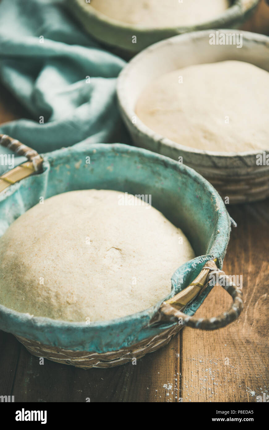 Sourdough for baking homemade wheat flour bread in baskets Stock Photo