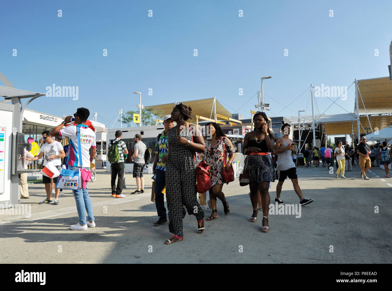 MILAN, ITALY – 06 30 2015: African black women walk proudly at the Milan Expo, universal exposition on the theme of food in Milan, Italy Stock Photo