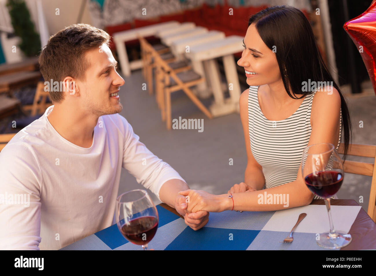 Smiling blonde-haired businessman taking care of his woman Stock Photo