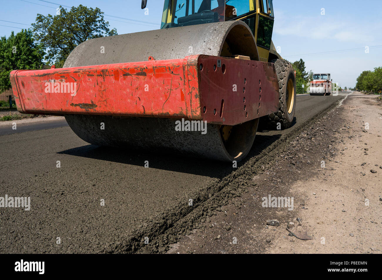Heavy Vibration roller at asphalt pavement working on the new road construction site. Repairing