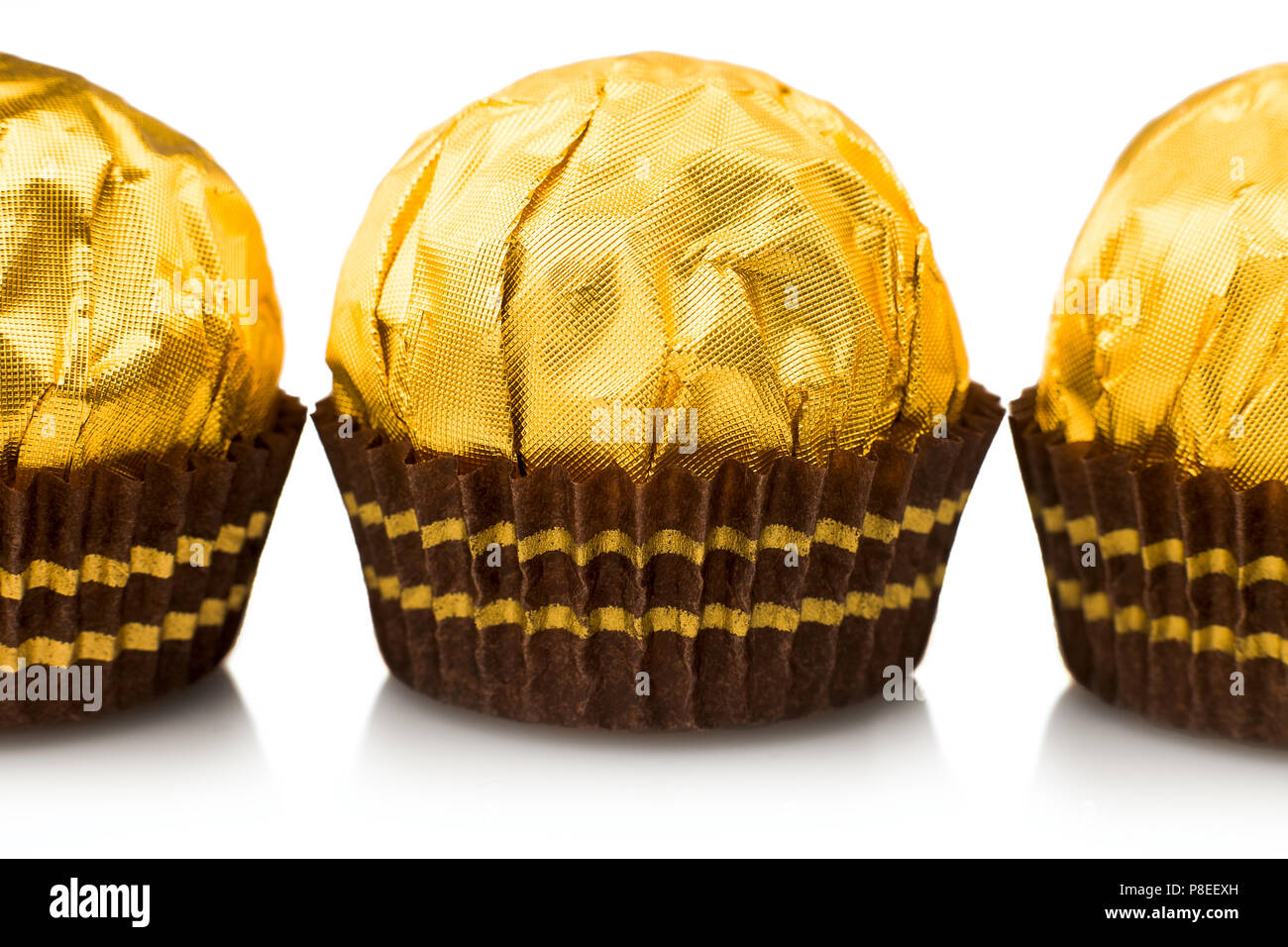 Candy in gold wrappers, isolated on white background Stock Photo Alamy