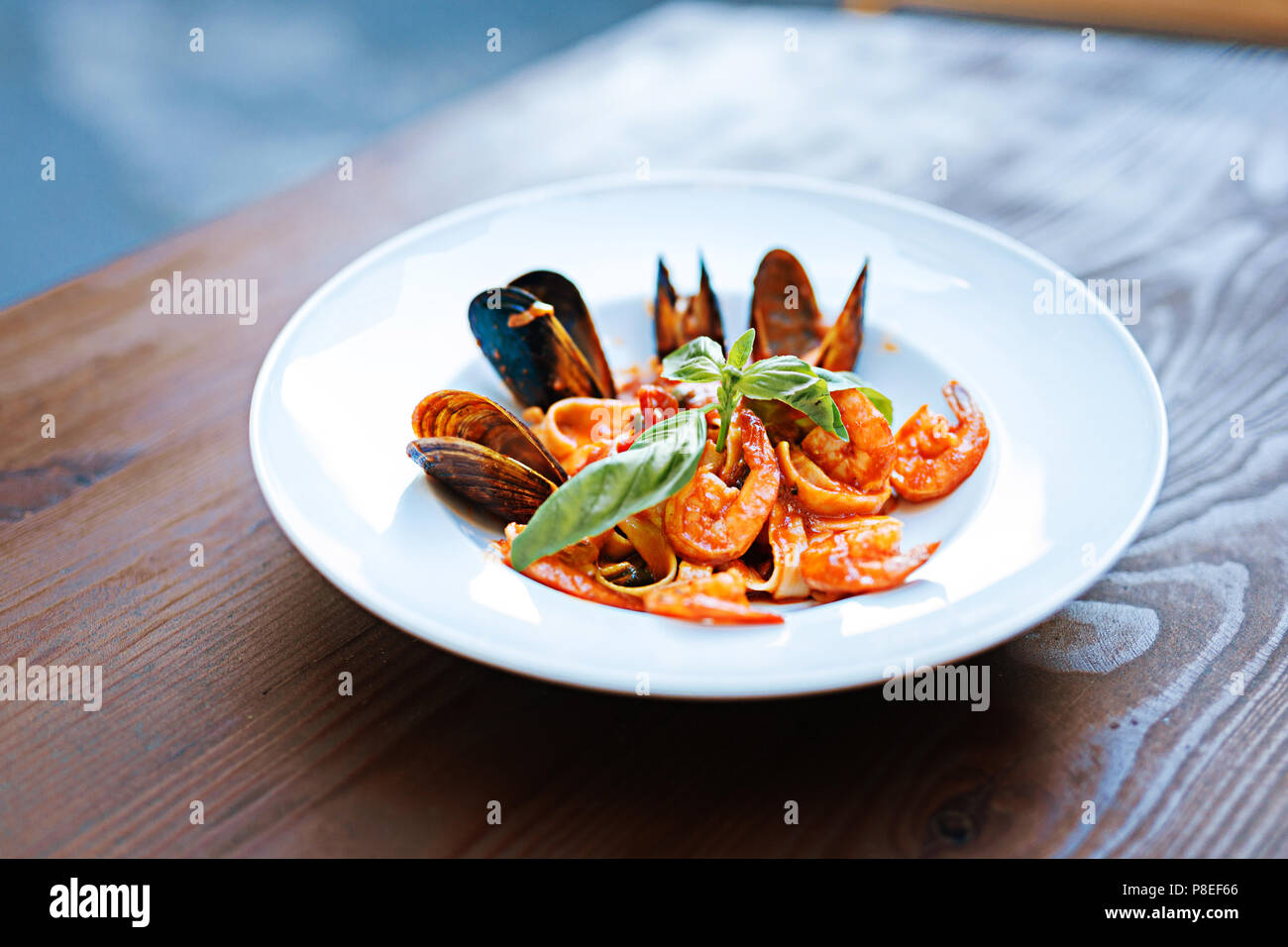 Close up of delicious pasta with some seafood in tomato sauce Stock Photo