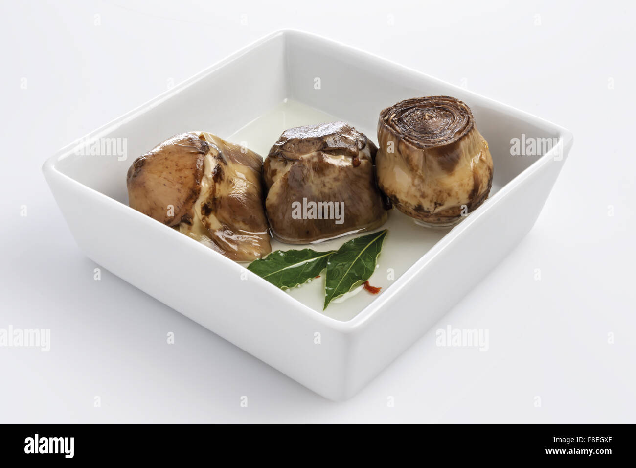 Artichokes in oil in white bowl 3 Stock Photo