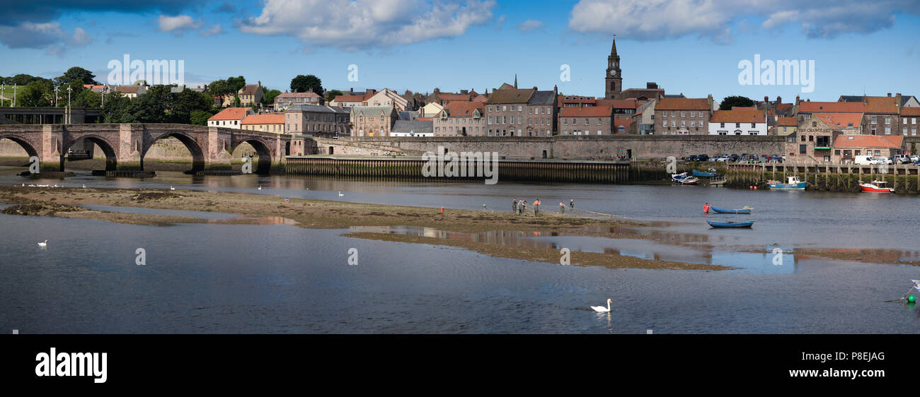 Berwick upon Tweed viewed from Tweedmouth with the Old Bridge, Guildhall, Town Walls and traditional salmon fishing at Gardo Stock Photo