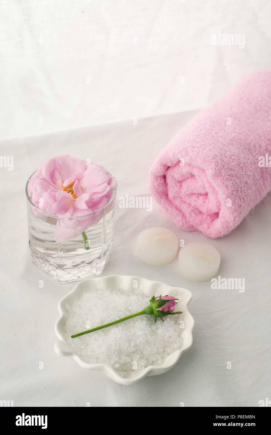 Spa resort therapy composition. Candles, rose flower, salt, towel