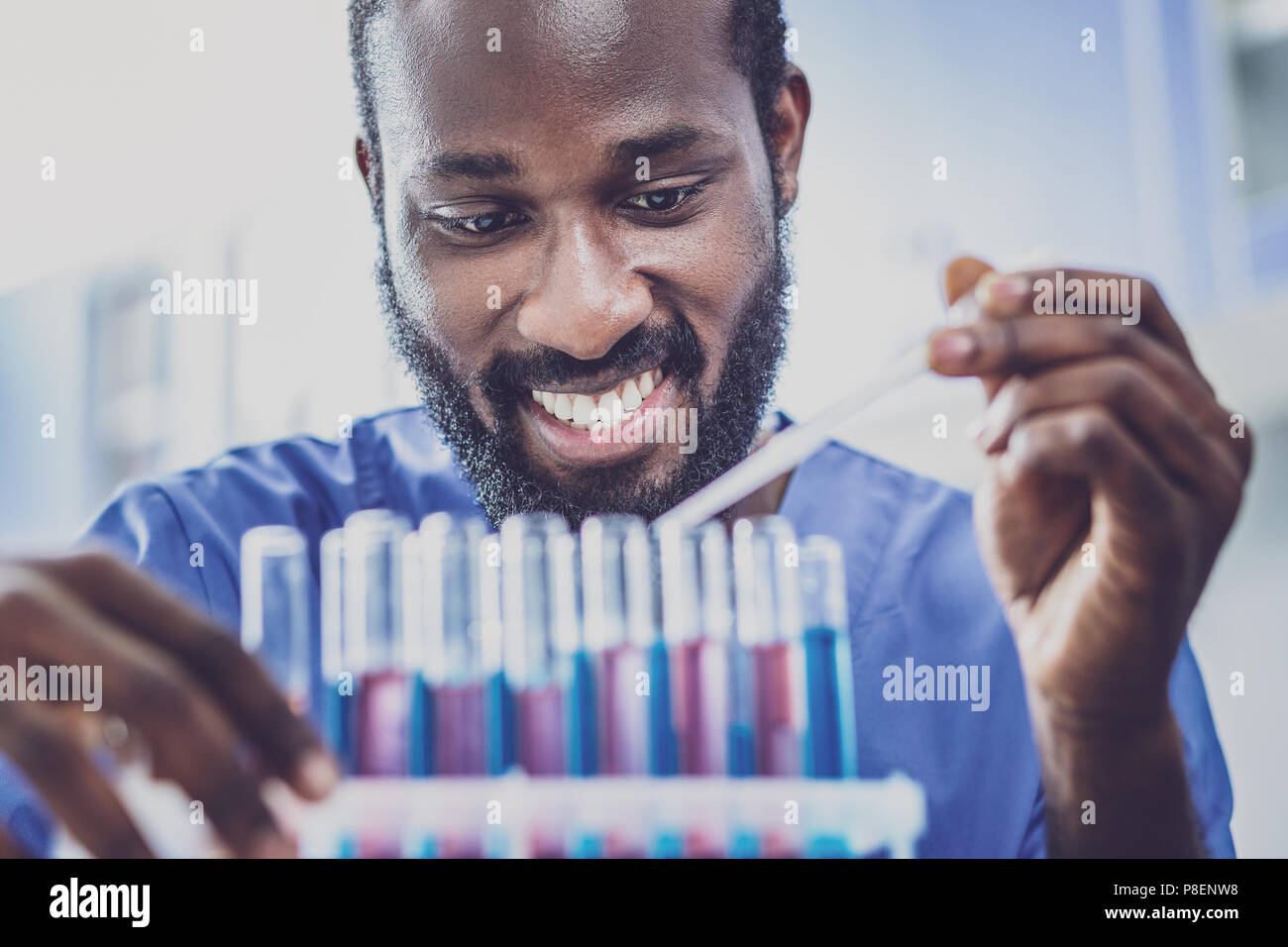 Smiling dark-haired biologist enjoying his activity Stock Photo