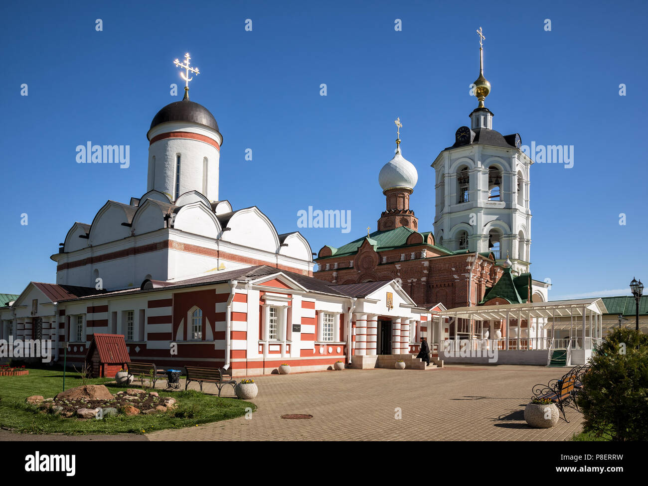 Architectural ensemble of the Nikolo-Peshnoshsky Monastery in Lugovoi. Monk enters temple. Moscow Region, Russia Stock Photo