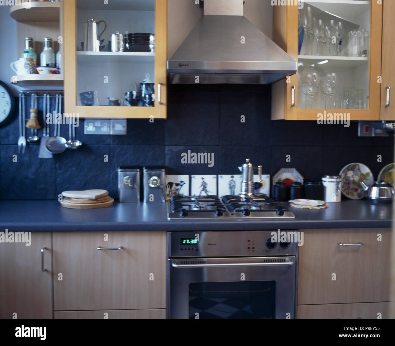 Stainlesssteel extractor above hob and oven in modern kitchen with