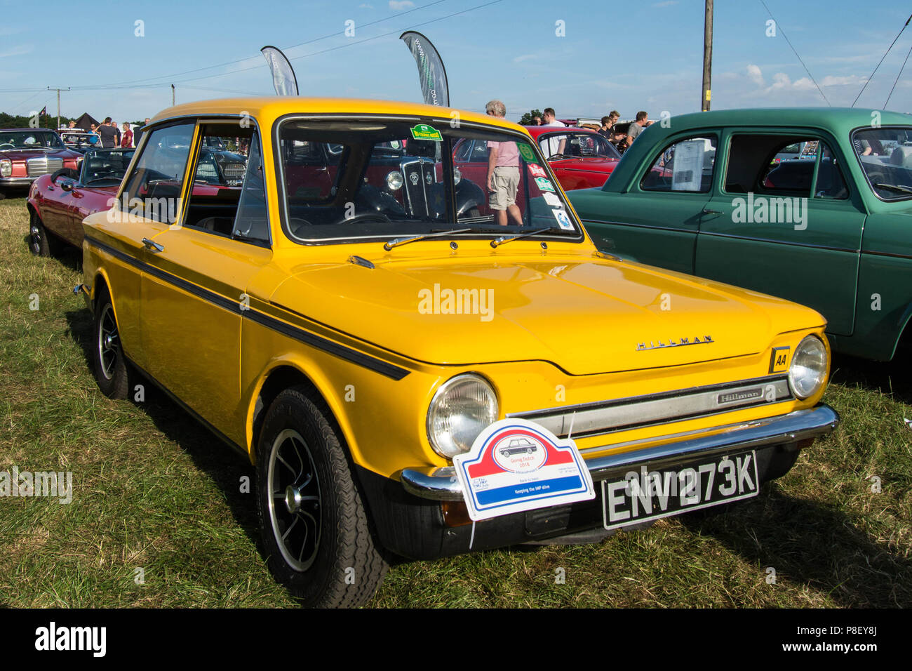 Classic cars Hillman Imp yellow vehicle old fashioned smart small little car vehicle style nice looks parked on show outside grass sign signs clean Stock Photo