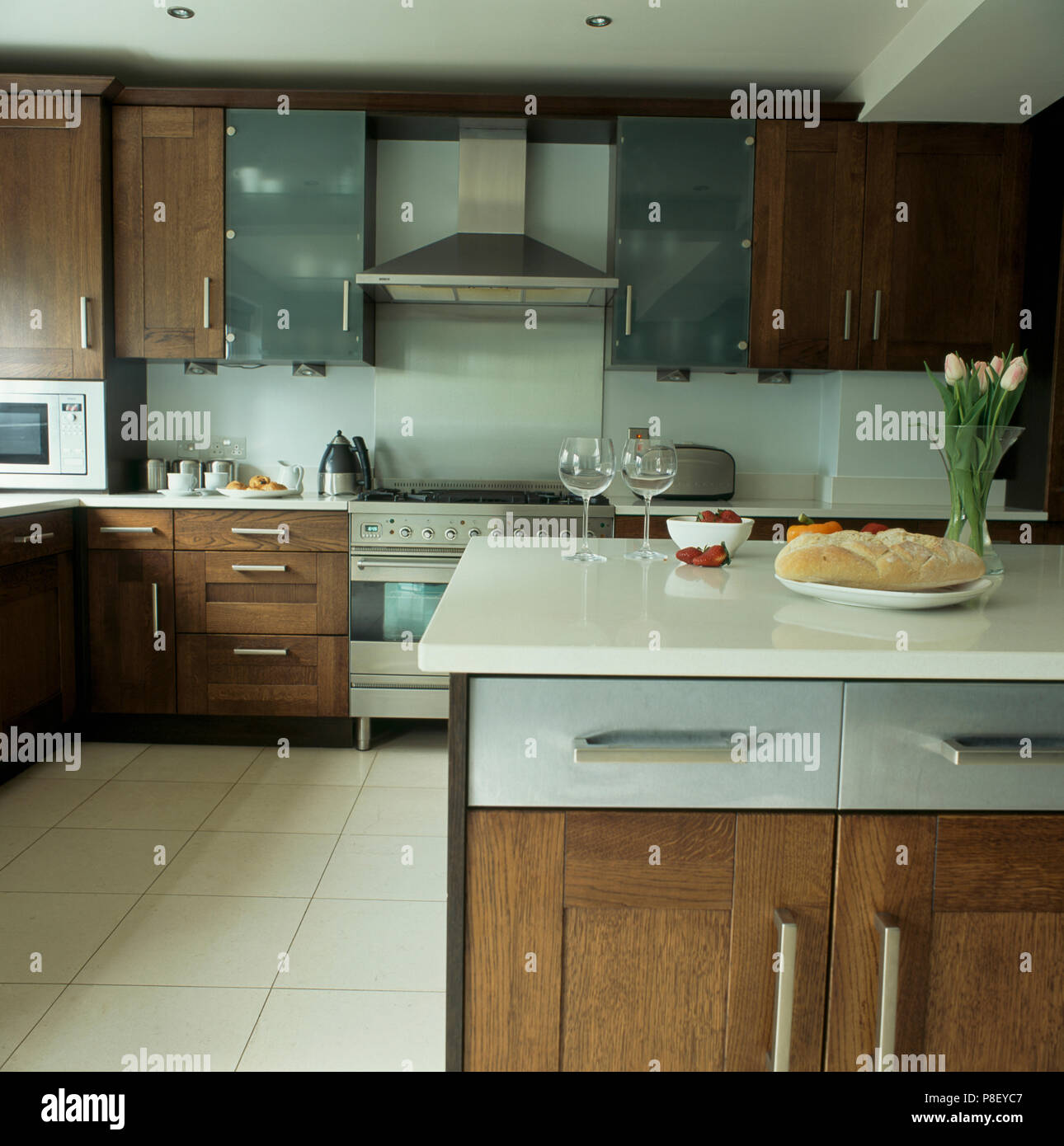 Modern Kitchen With White Worktops And Dark Wood Units Stock Photo Alamy