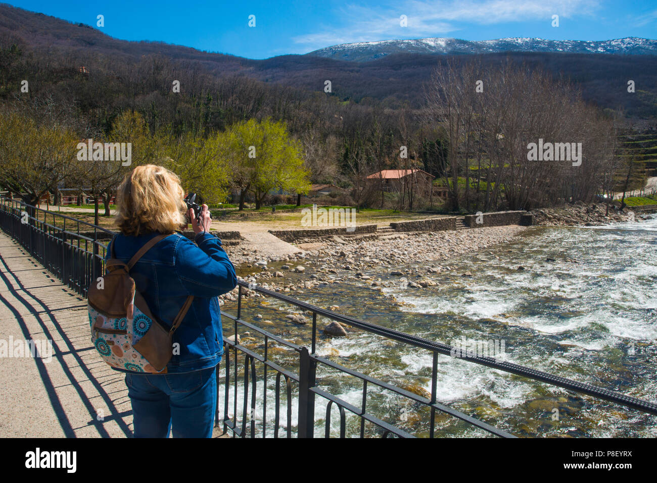 Woman taking photos of  river Jerte. Jerte, caceres province, Extremadura, Spain. Stock Photo
