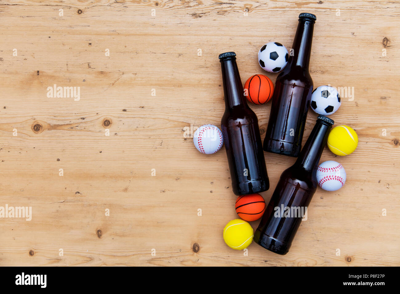 Sports match party. Beer bottle with football, basketball, baseball balls Stock Photo Alamy