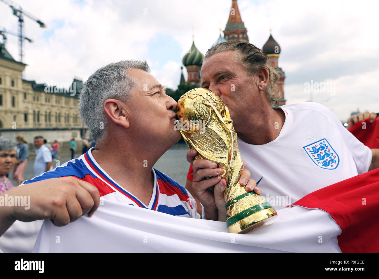 England fans pose for a picture with a replica World Cup trophy in Red ...