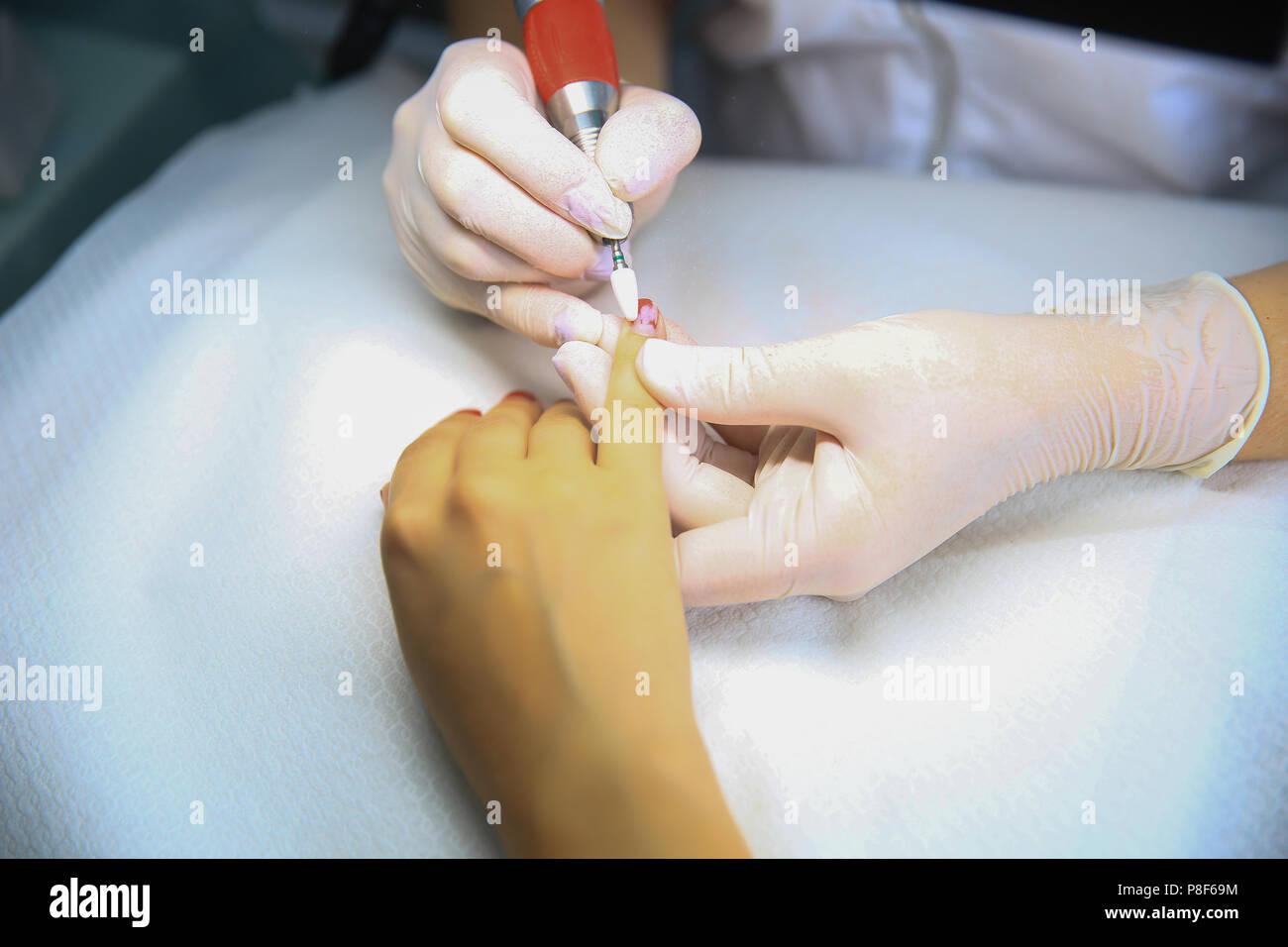Sawing nails removing manicure, professional work in the beauty salon Stock Photo