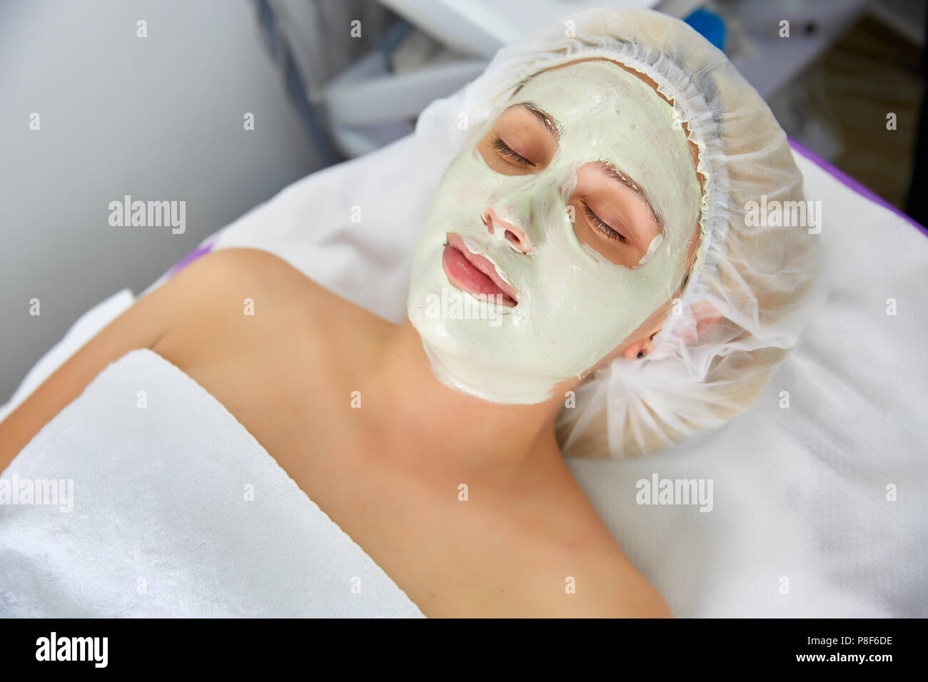 Face peeling mask, spa beauty treatment, skincare. Woman getting facial