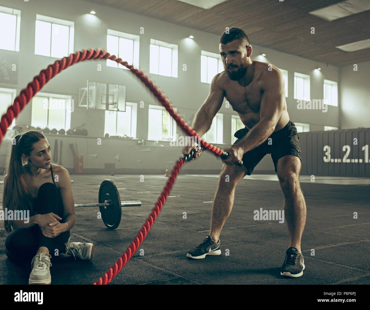 Men with battle rope battle ropes exercise in the fitness gym Stock Photo -  Alamy