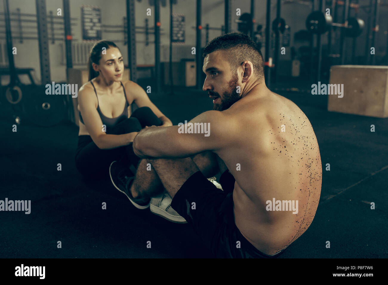 Man and woman during exercises in the fitness gym Stock Photo - Alamy